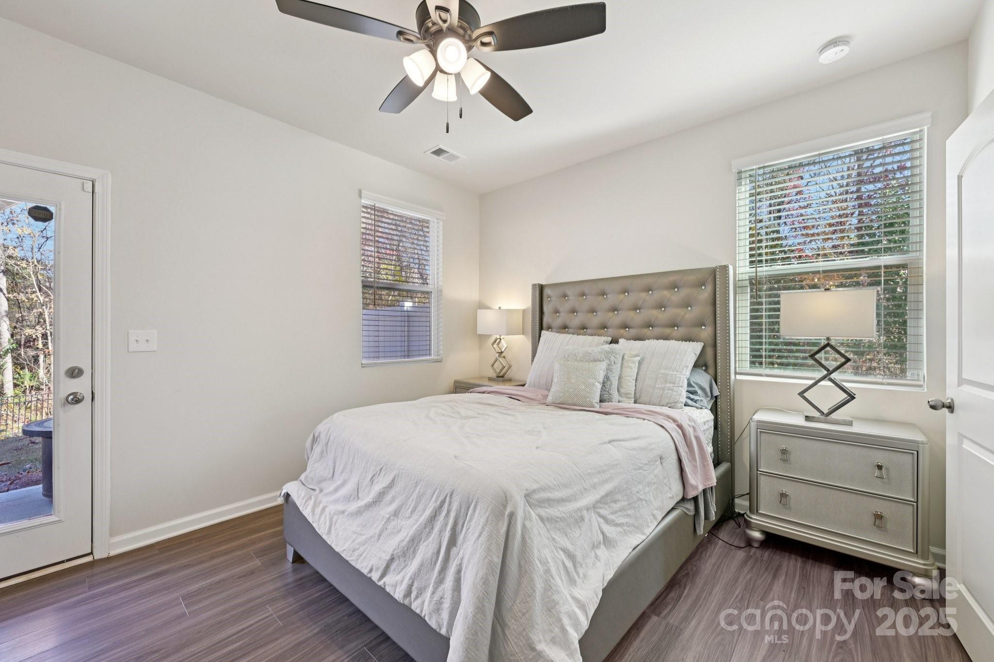 2932 Pirates Place Charlotte, NC 28216 - Photo 16 of 32 a bedroom with a large bed and a chandelier fan