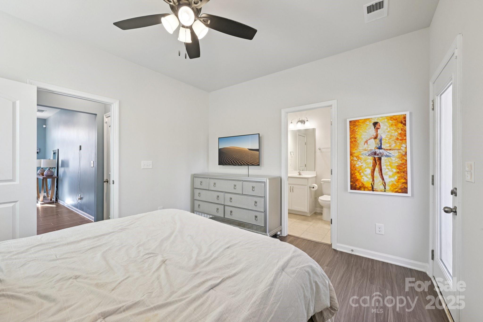 2932 Pirates Place Charlotte, NC 28216 - Photo 18 of 32 a bedroom with a bed and a flat screen tv