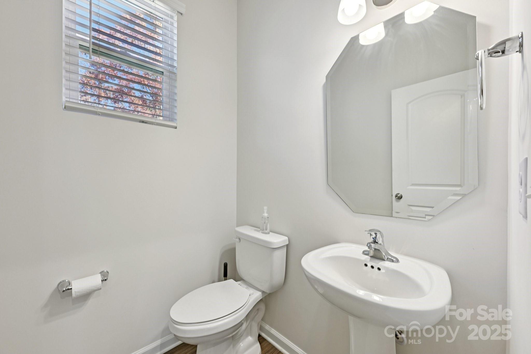 2932 Pirates Place Charlotte, NC 28216 - Photo 20 of 32 a bathroom with a sink a mirror and a toilet