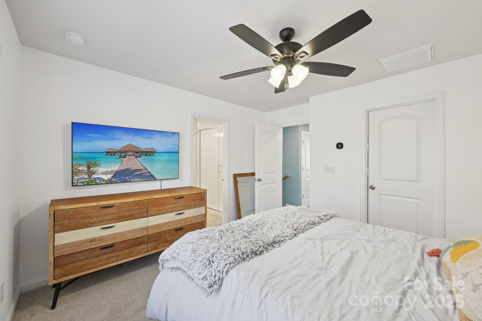 2932 Pirates Place Charlotte, NC 28216 - Photo 22 of 32 a bedroom with a bed and a chandelier