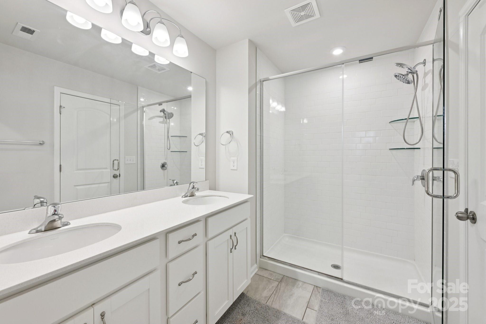 2932 Pirates Place Charlotte, NC 28216 - Photo 23 of 32 a bathroom with a double vanity sink mirror and shower