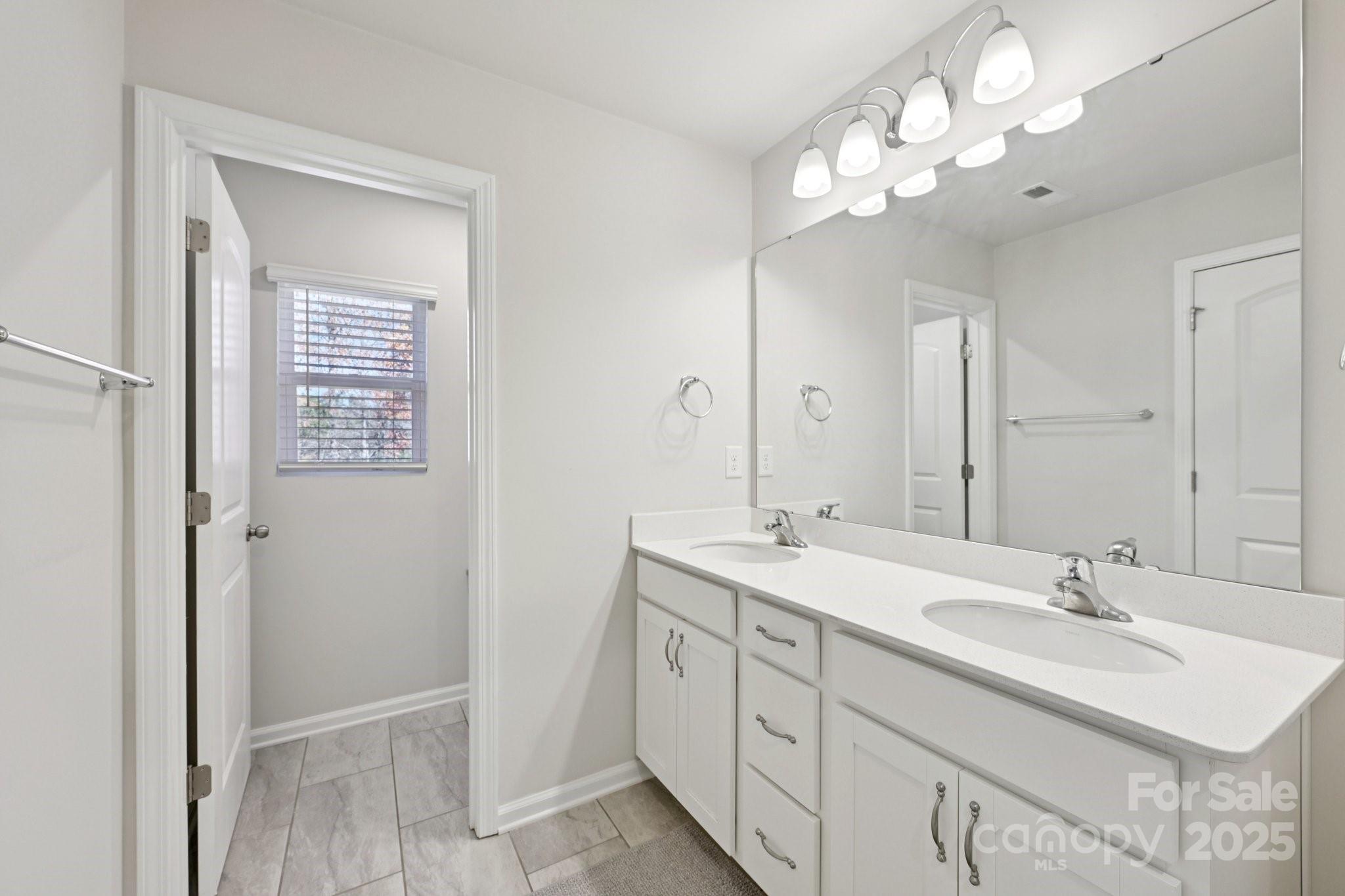 2932 Pirates Place Charlotte, NC 28216 - Photo 24 of 32 a bathroom with a sink double vanity and a mirror