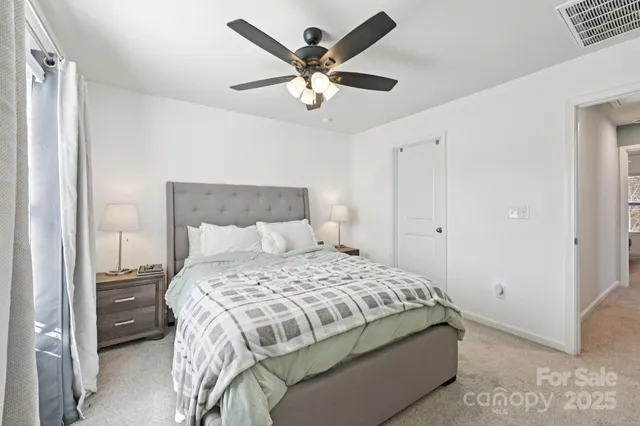 a bedroom with a bed and ceiling fan