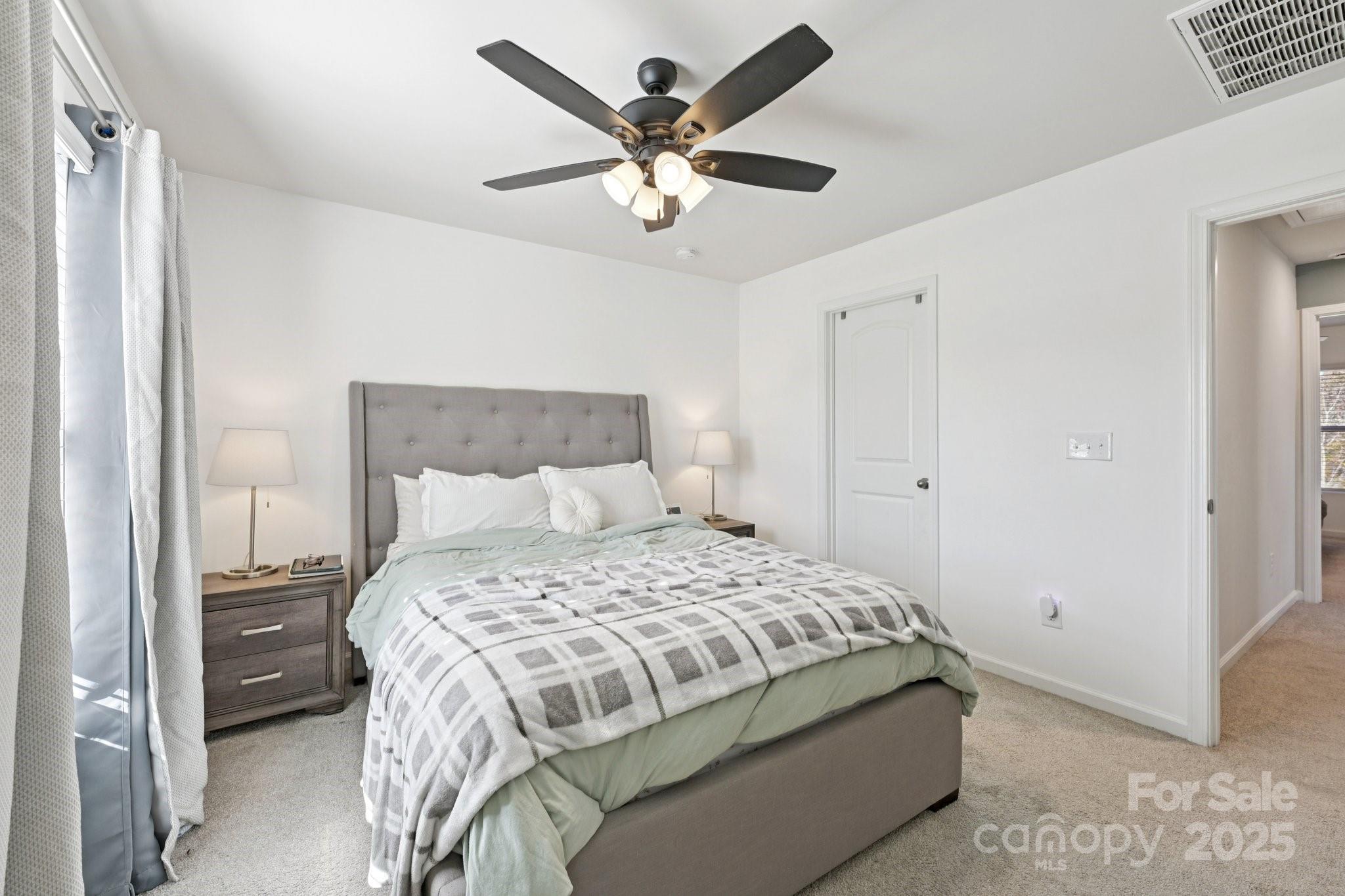 2932 Pirates Place Charlotte, NC 28216 - Photo 25 of 32 a bedroom with a bed and ceiling fan
