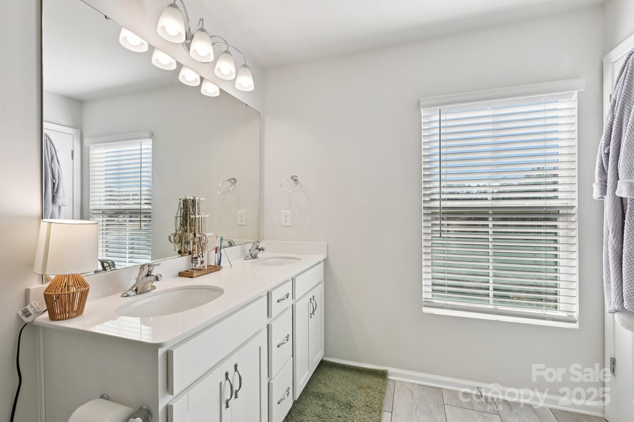 2932 Pirates Place Charlotte, NC 28216 - Photo 26 of 32 a bathroom with a sink a vanity and a mirror