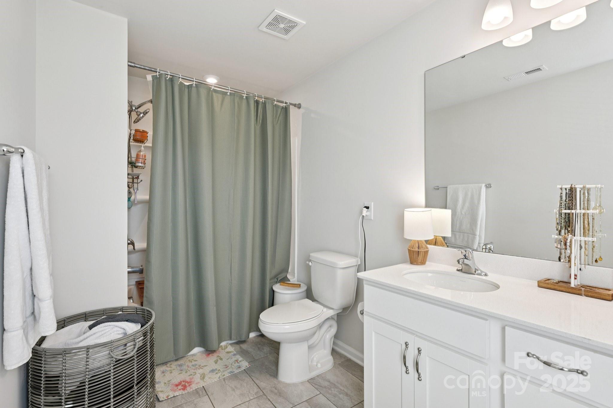 2932 Pirates Place Charlotte, NC 28216 - Photo 27 of 32 a bathroom with a sink a toilet and shower