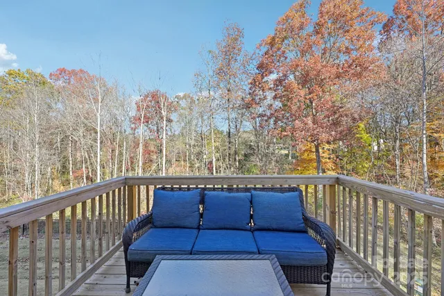 a view of a balcony with wooden floor and fence