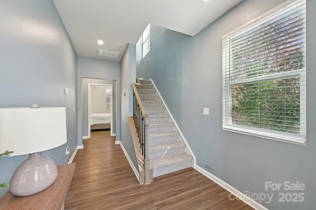 a view of entryway and hall with wooden floor