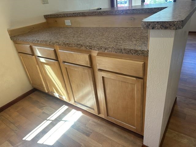 673 Minaret Road June Lake, CA 93529 - Photo 16 of 22 Light-toned wood-finish cabinetry with a laminate countertop, featuring an integrated breakfast bar
