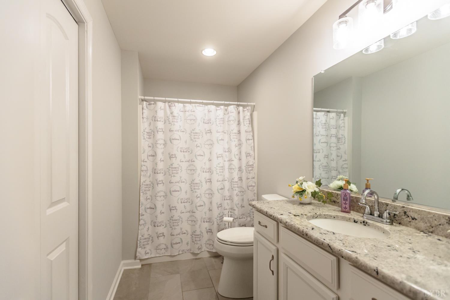 7099 Oakville Road Appomattox, VA 24522 - Photo 13 of 31 a bathroom with a granite countertop sink toilet and shower