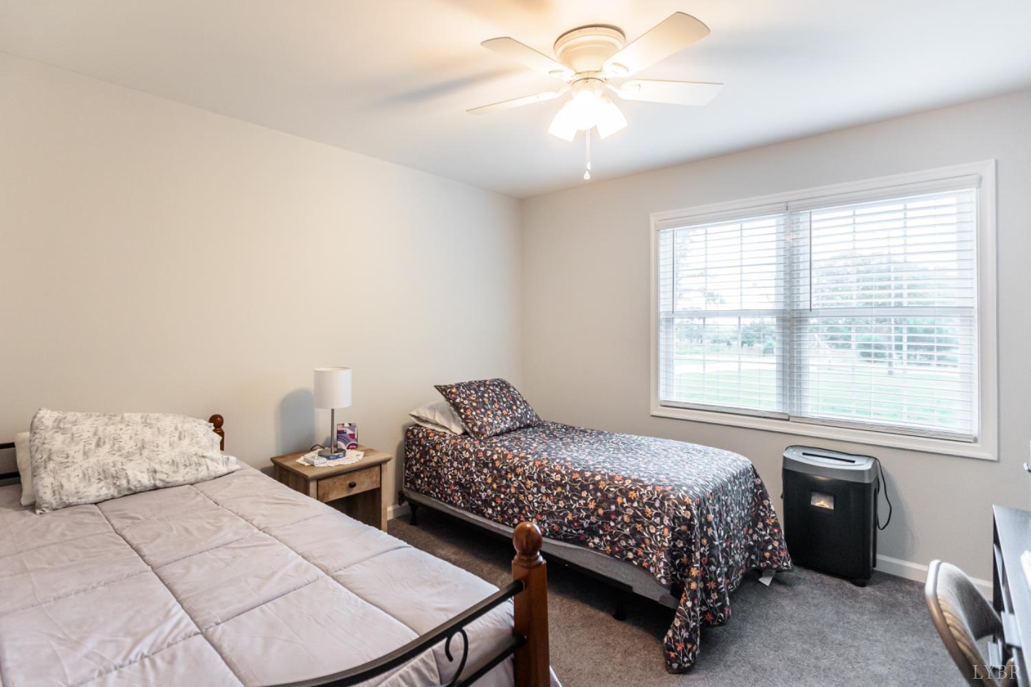 7099 Oakville Road Appomattox, VA 24522 - Photo 15 of 31 a bedroom with a bed and a chandelier
