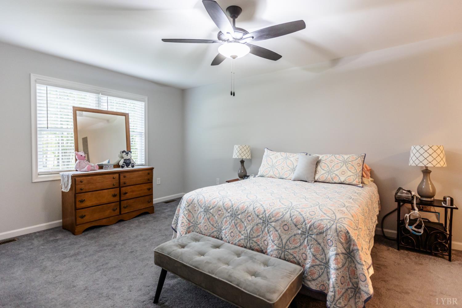 7099 Oakville Road Appomattox, VA 24522 - Photo 18 of 31 a bedroom with a bed and a chandelier