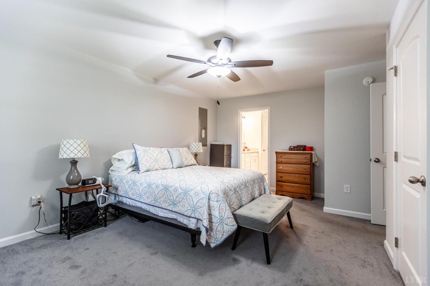 7099 Oakville Road Appomattox, VA 24522 - Photo 19 of 31 a bedroom with a bed and a chandelier