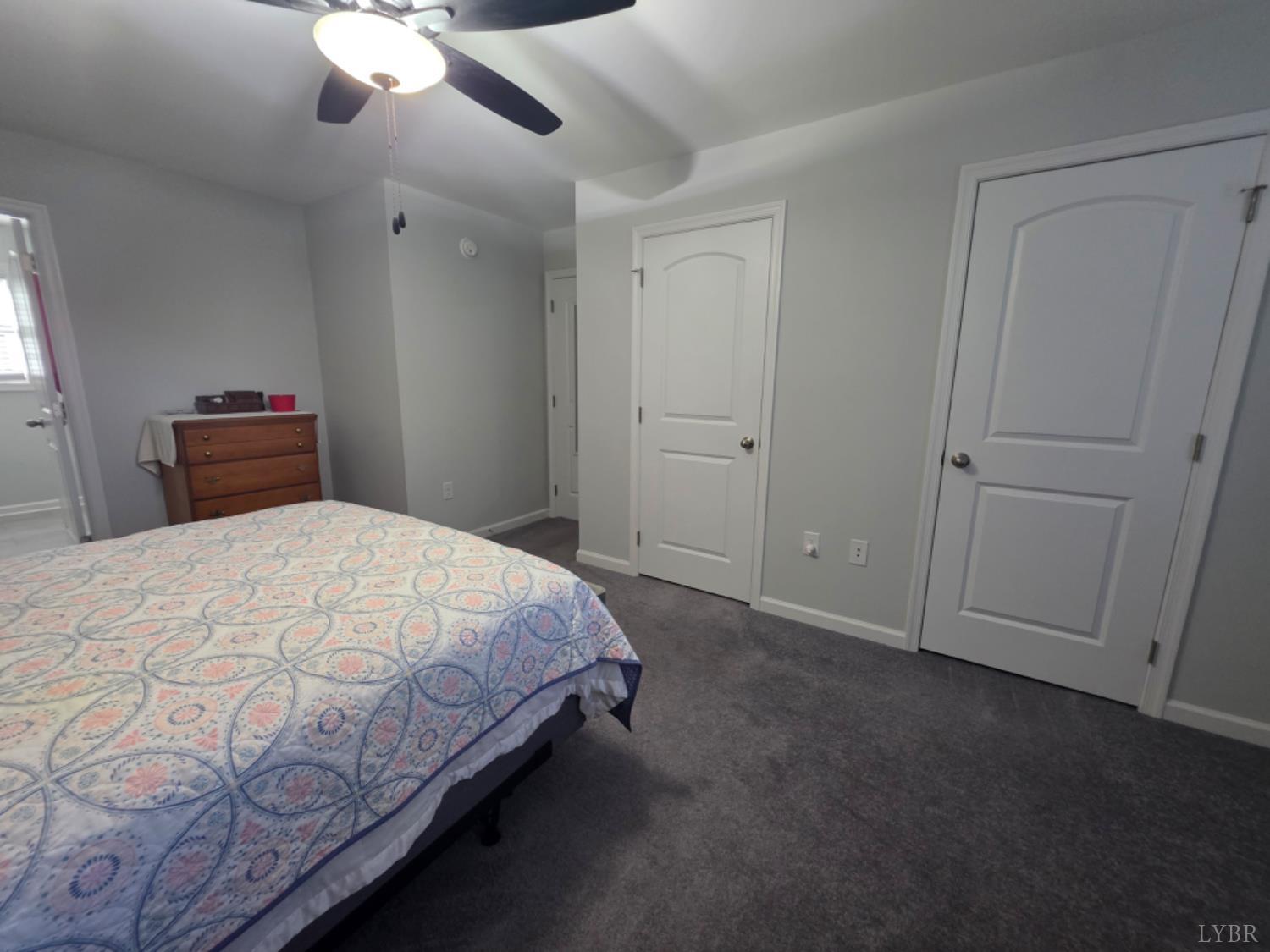 7099 Oakville Road Appomattox, VA 24522 - Photo 20 of 31 a bedroom with a bed and a chandelier