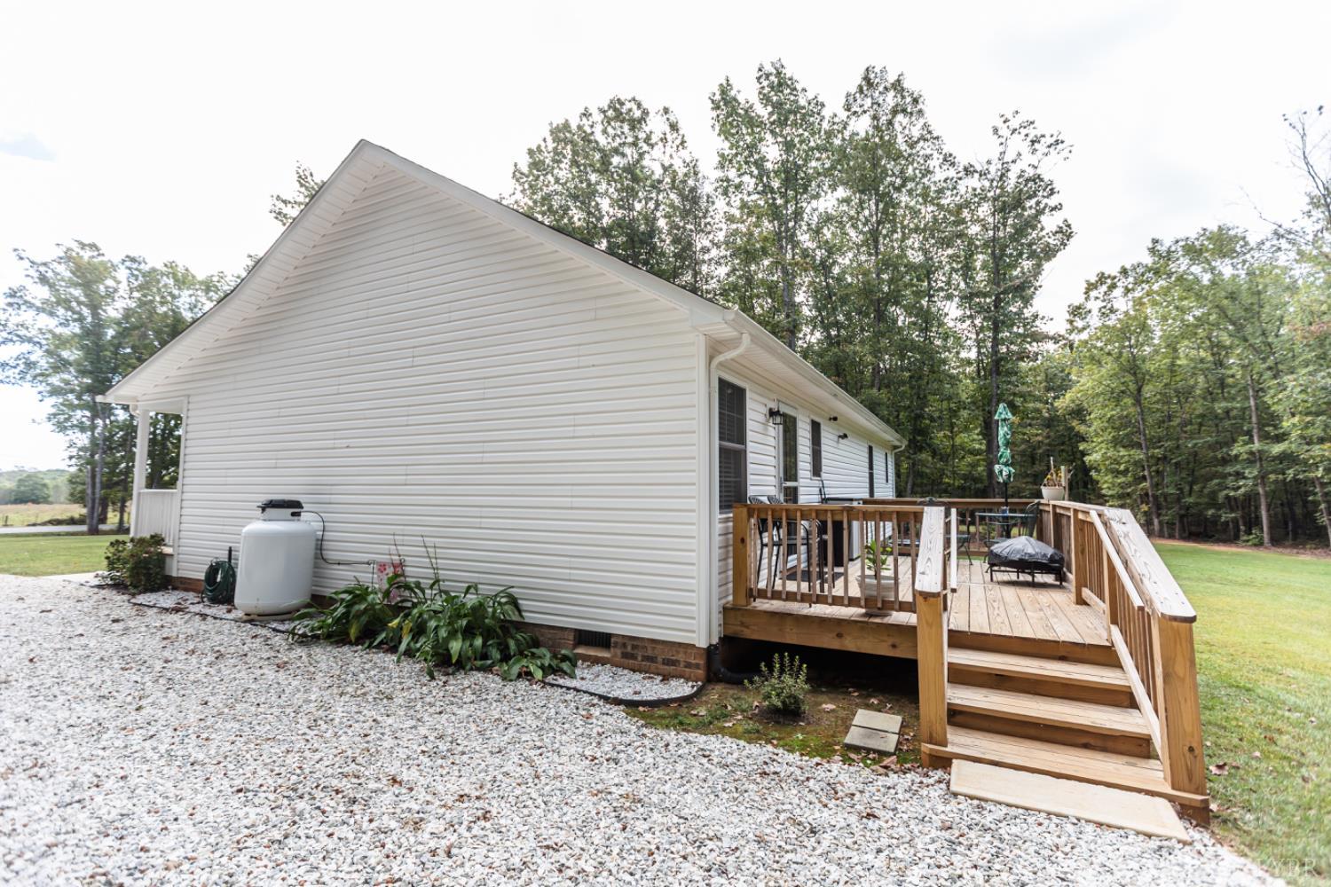 7099 Oakville Road Appomattox, VA 24522 - Photo 28 of 31 a view of a house with a yard and furniture