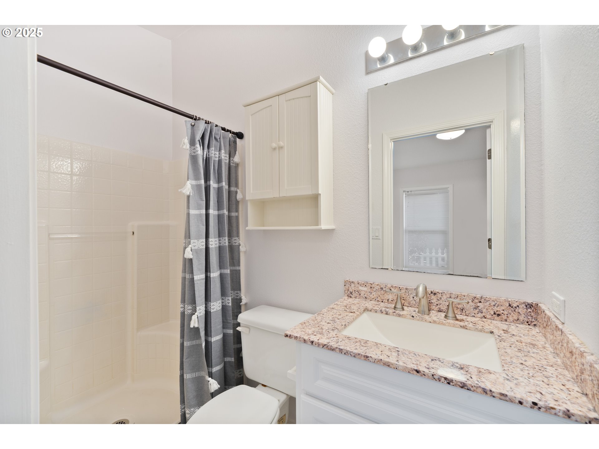 10425 Neahkahnie Creek Road Nehalem, OR 97131 - Photo 37 of 48 a bathroom with a granite countertop sink mirror and a shower