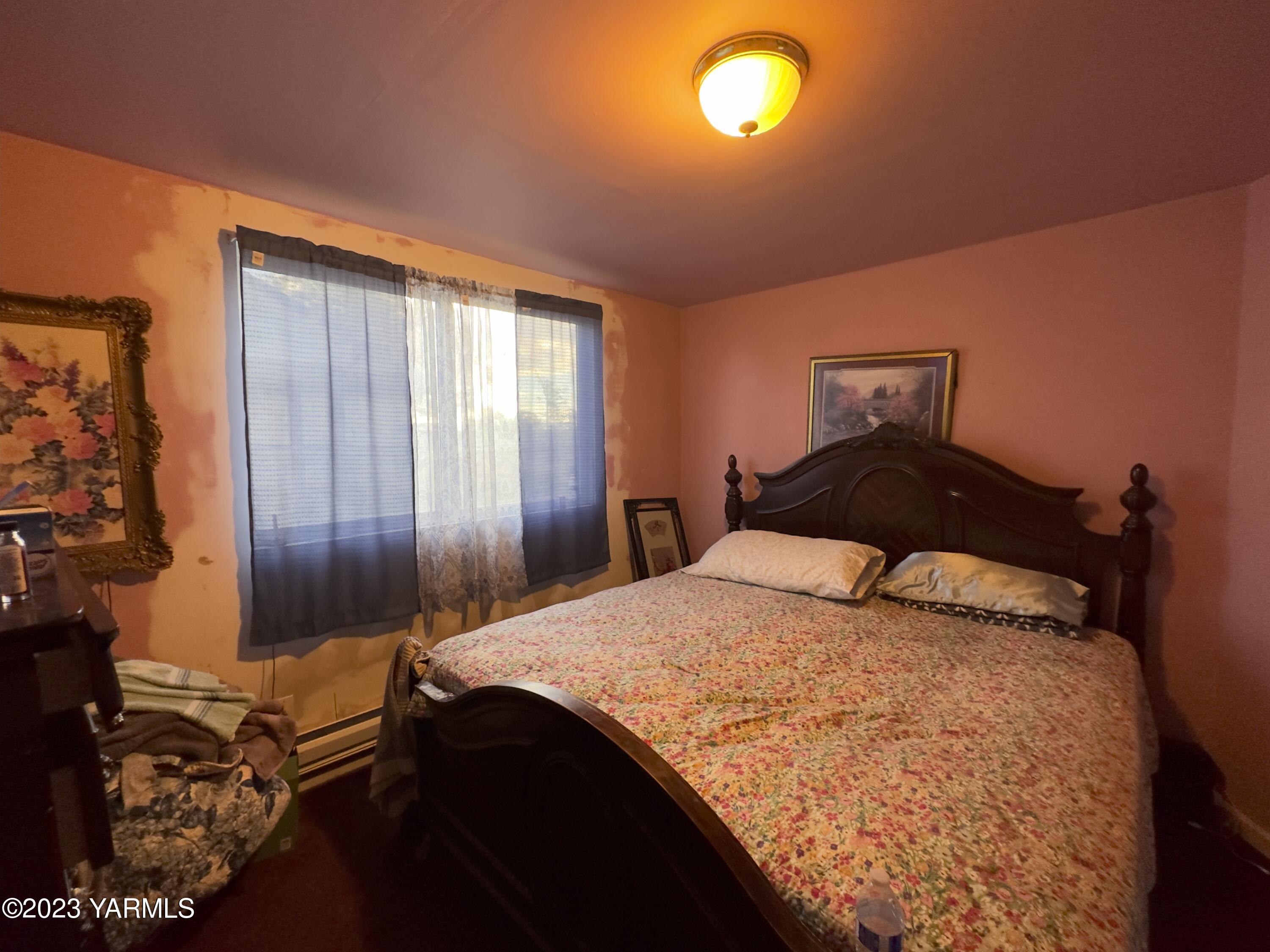 450 Main Street Parker, WA 98939 - Photo 13 of 18 a bedroom with a bed and a dresser