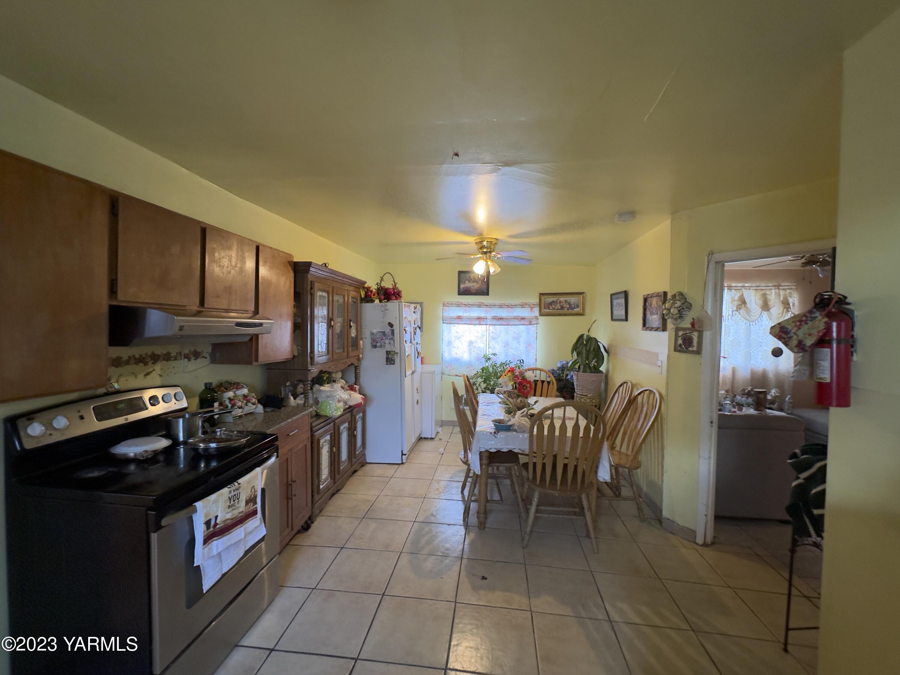 450 Main Street Parker, WA 98939 - Photo 14 of 18 a kitchen with a table chairs and a refrigerator