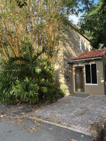 a view of a house with a tree