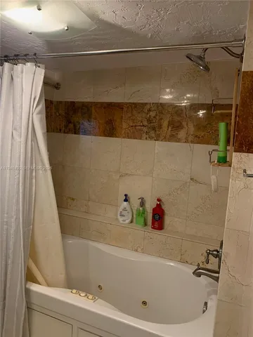 a bathroom with a bathtub and shower
