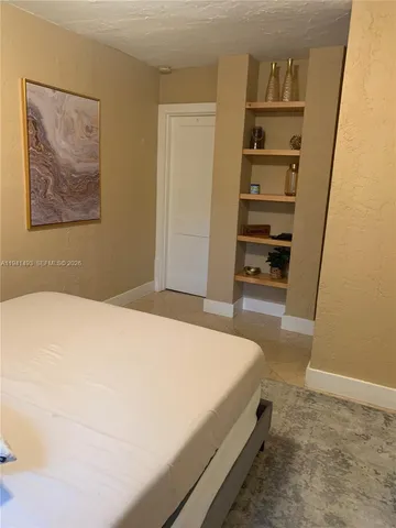 a bedroom with a bed and closet