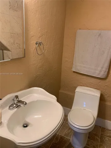 a bathroom with a sink and toilet