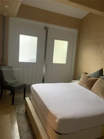 a bedroom with a bed and window