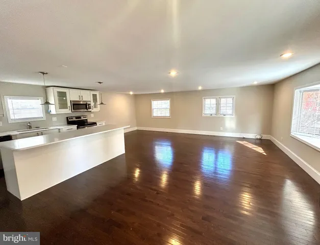 a large kitchen with lots of counter top space and a refrigerator
