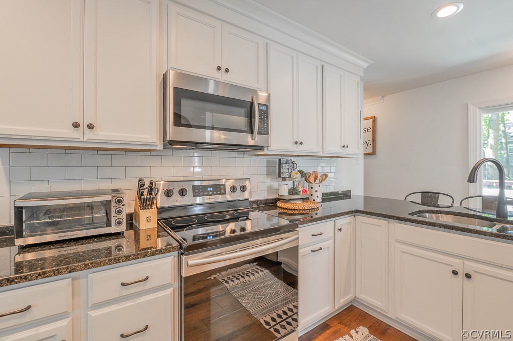 5906 Acorn Ridge Court Midlothian, VA 23112 - Photo 13 of 48 a kitchen with granite countertop white cabinets and white appliances