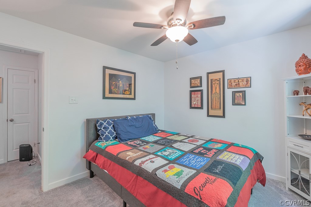 5906 Acorn Ridge Court Midlothian, VA 23112 - Photo 26 of 48 a bedroom with a bed and a chandelier