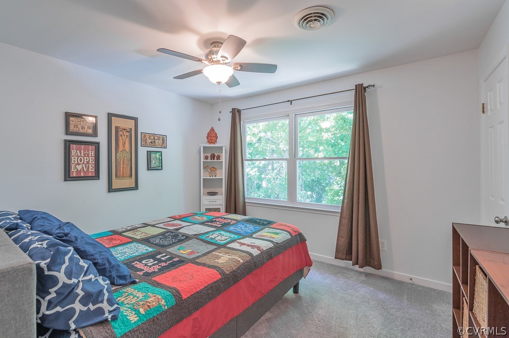 5906 Acorn Ridge Court Midlothian, VA 23112 - Photo 30 of 48 a bedroom with a bed and a chandelier