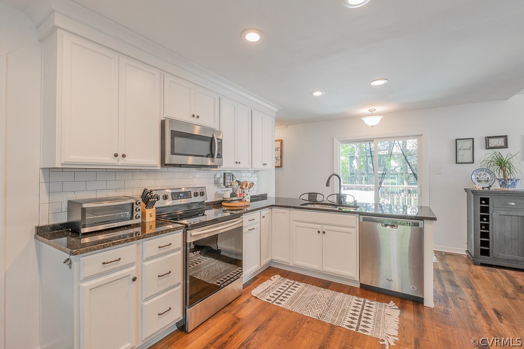 5906 Acorn Ridge Court Midlothian, VA 23112 - Photo 7 of 48 a kitchen with granite countertop cabinets stainless steel appliances a sink and a window