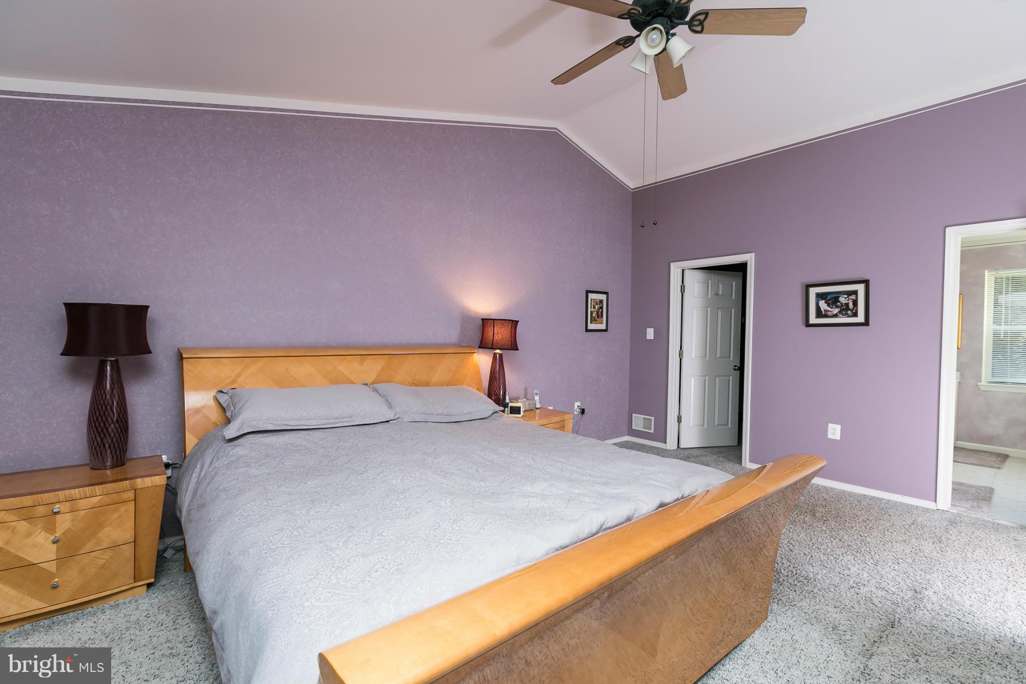 6824 Old Pimlico Road Baltimore, MD 21209 - Photo 11 of 20 a bed sitting in a bedroom next to a lamp