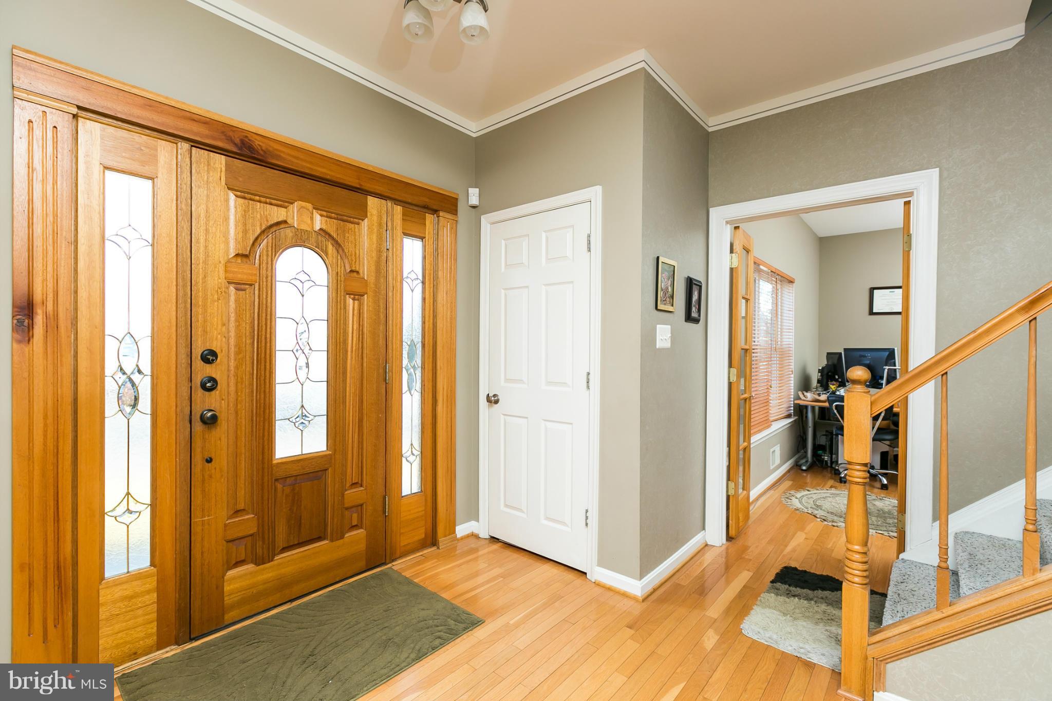 6824 Old Pimlico Road Baltimore, MD 21209 - Photo 3 of 20 a view of an entryway with wooden floor and a livingroom view