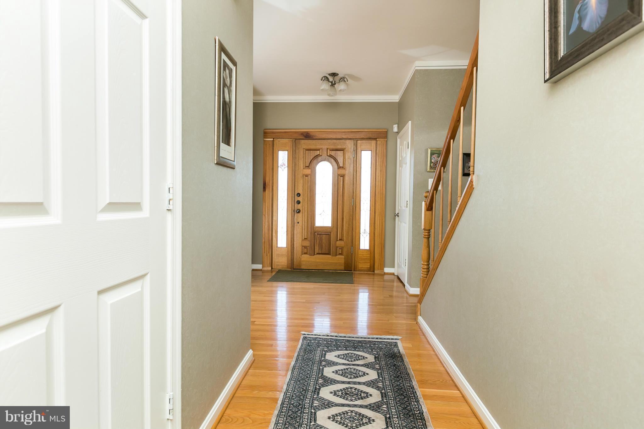 6824 Old Pimlico Road Baltimore, MD 21209 - Photo 4 of 20 a hallway with wooden floor and a rug