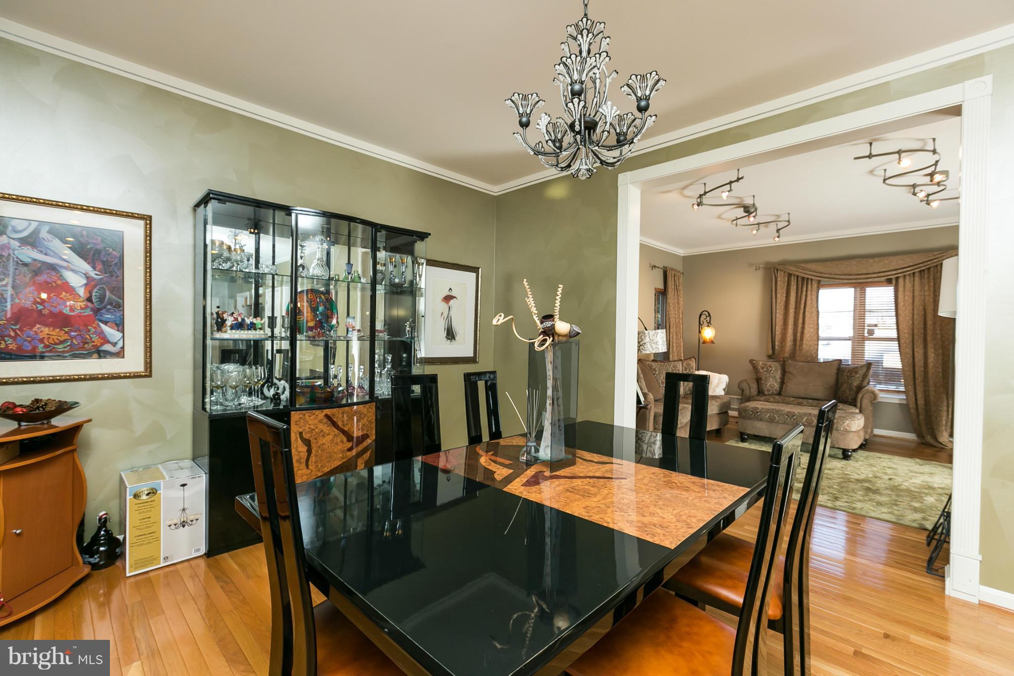 6824 Old Pimlico Road Baltimore, MD 21209 - Photo 6 of 20 a dining room with furniture a chandelier and wooden floor