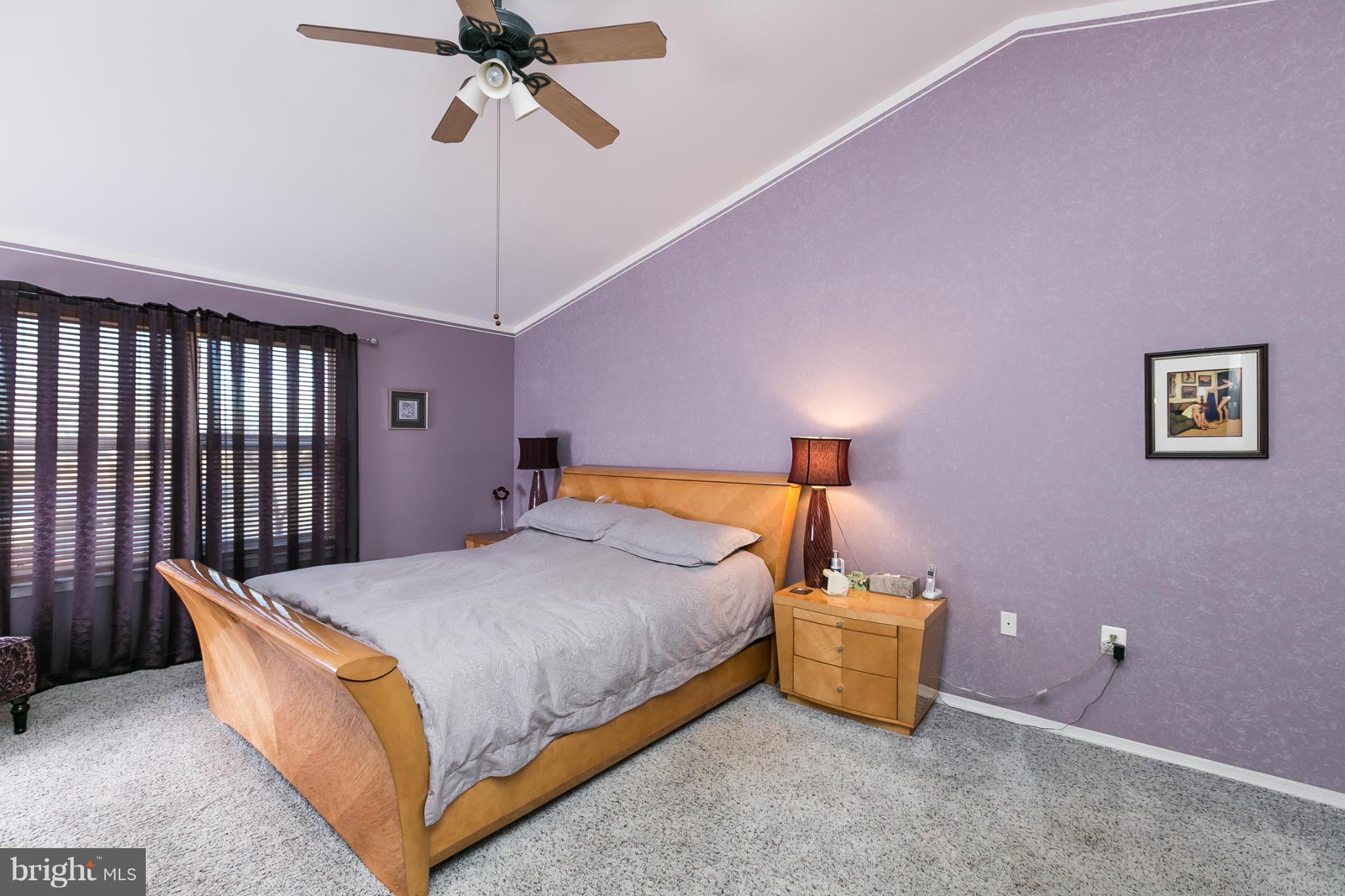 6824 Old Pimlico Road Baltimore, MD 21209 - Photo 10 of 20 a bedroom with a bed and a chandelier