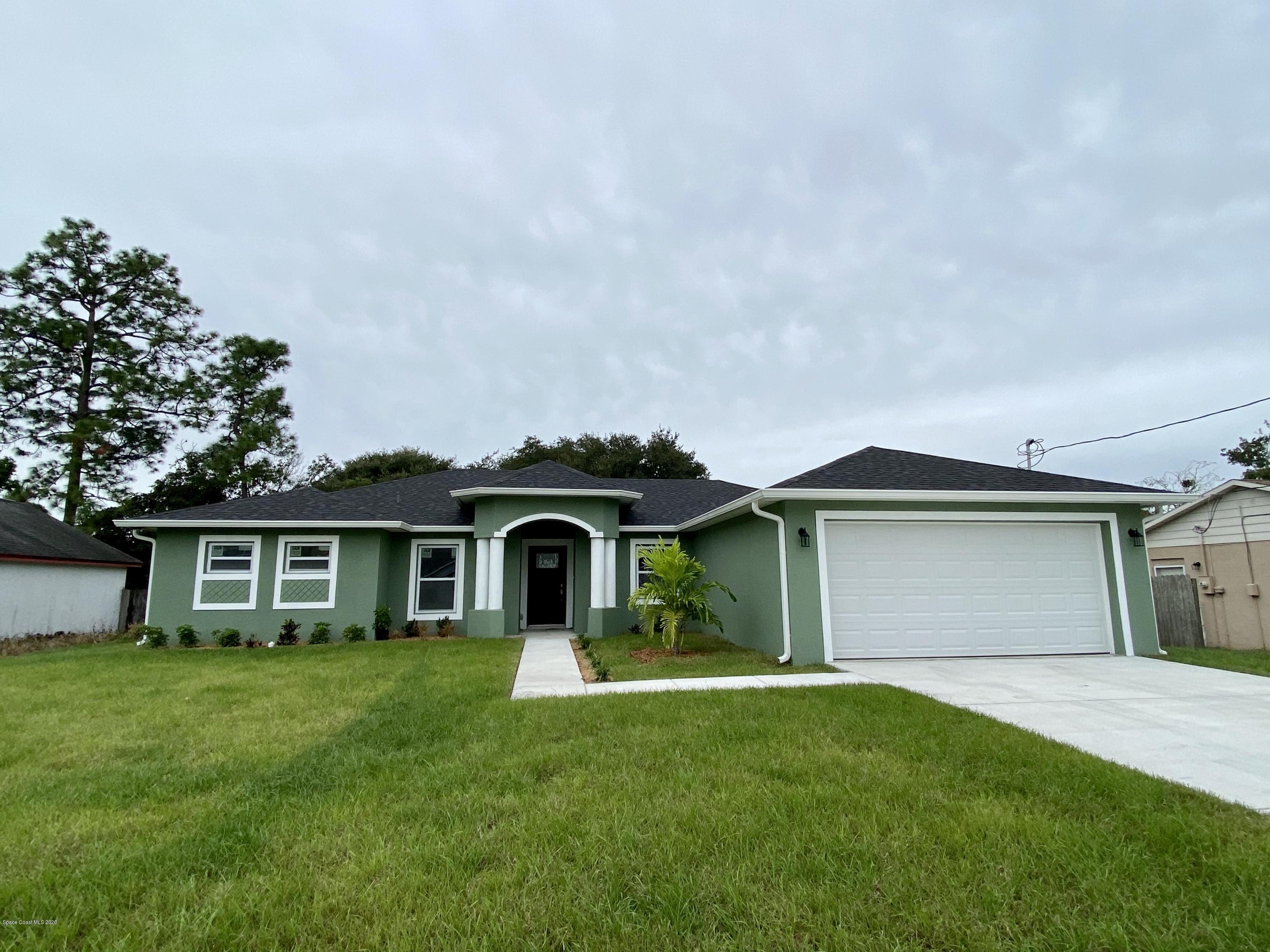 6444 Hudson Road Cocoa, FL 32927 - Photo 1 of 21 a front view of a house with a garden