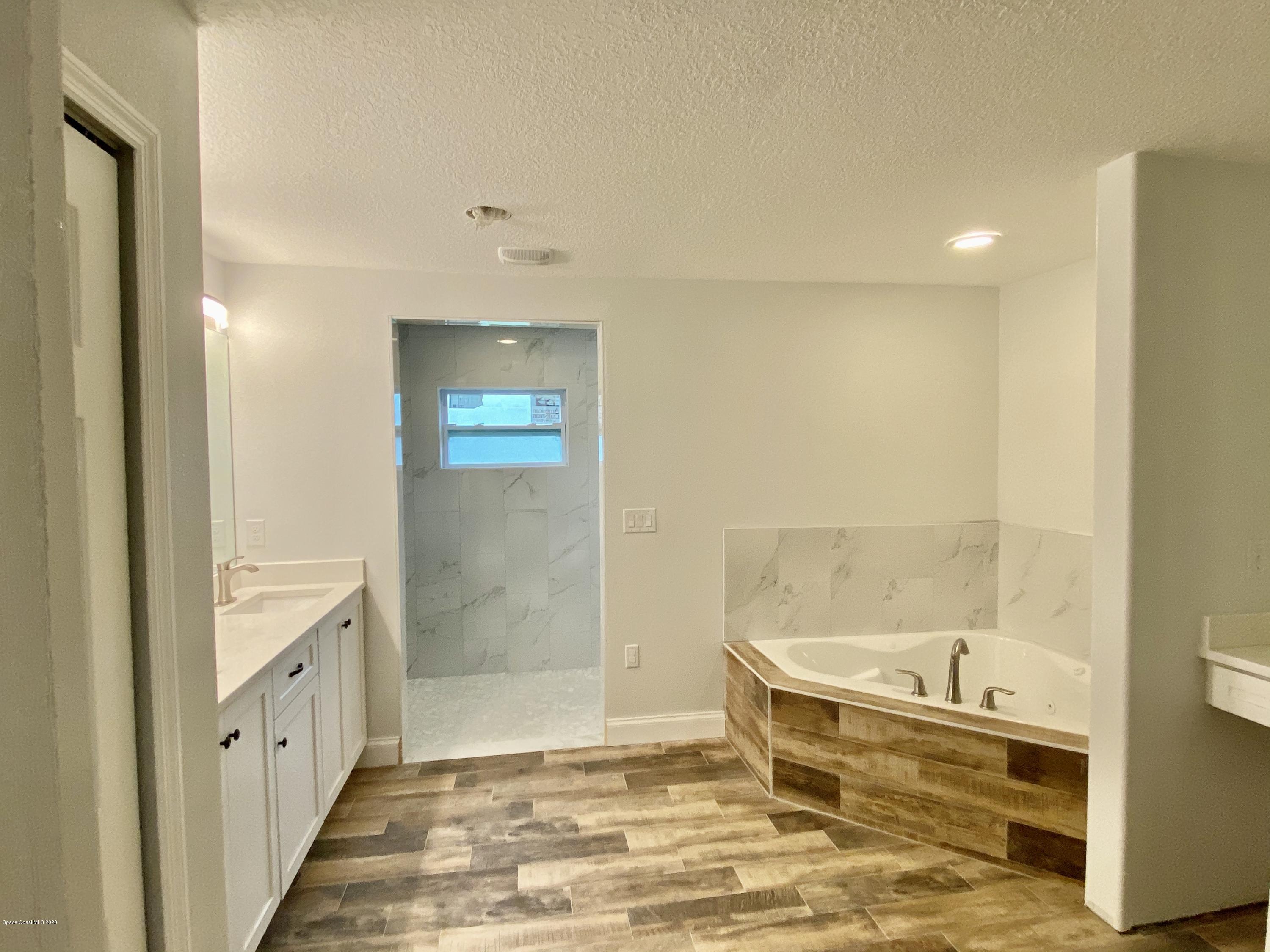 6444 Hudson Road Cocoa, FL 32927 - Photo 13 of 21 a bathroom with a tub and shower