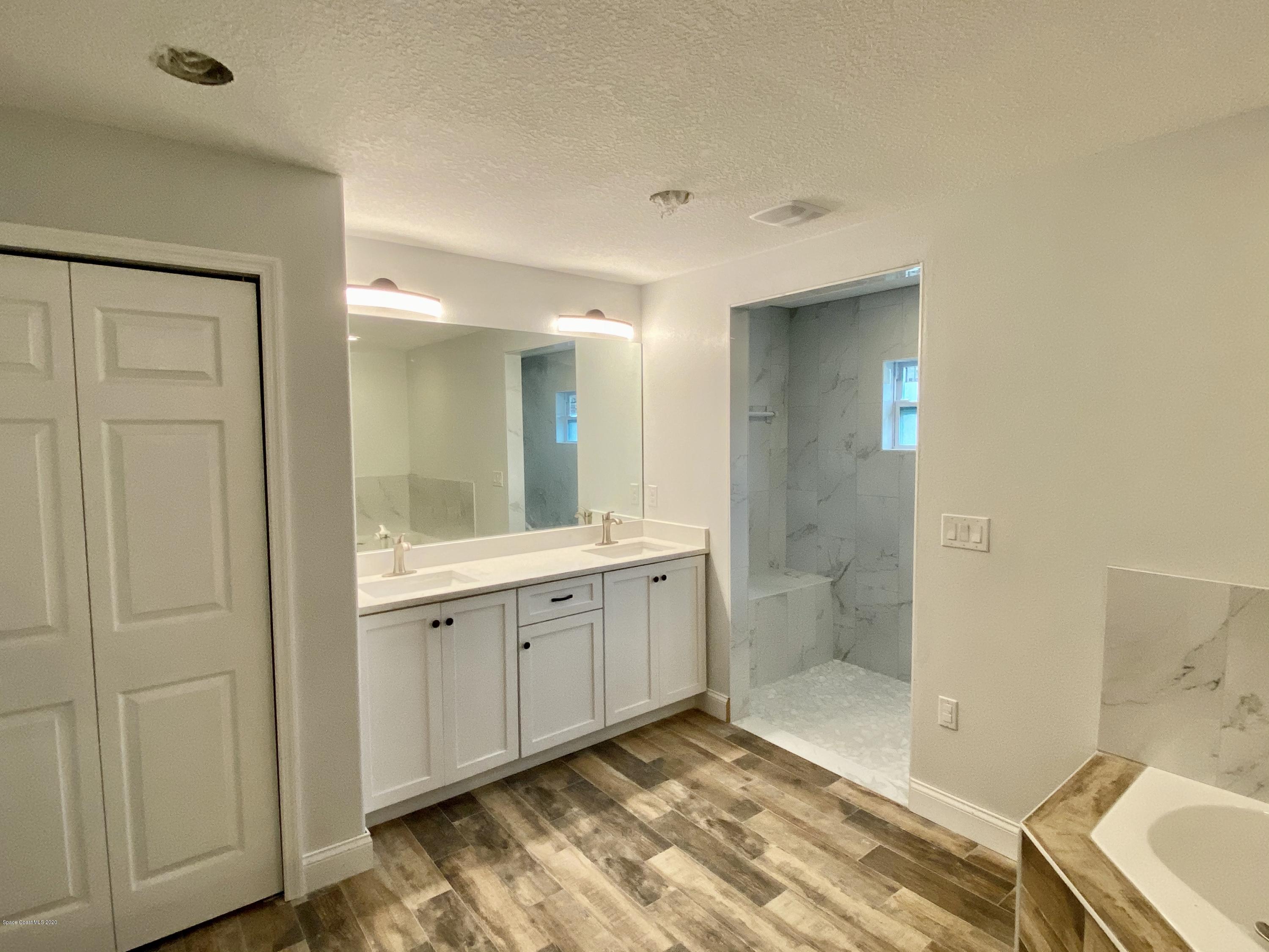 6444 Hudson Road Cocoa, FL 32927 - Photo 14 of 21 a spacious bathroom with a granite countertop sink and a mirror