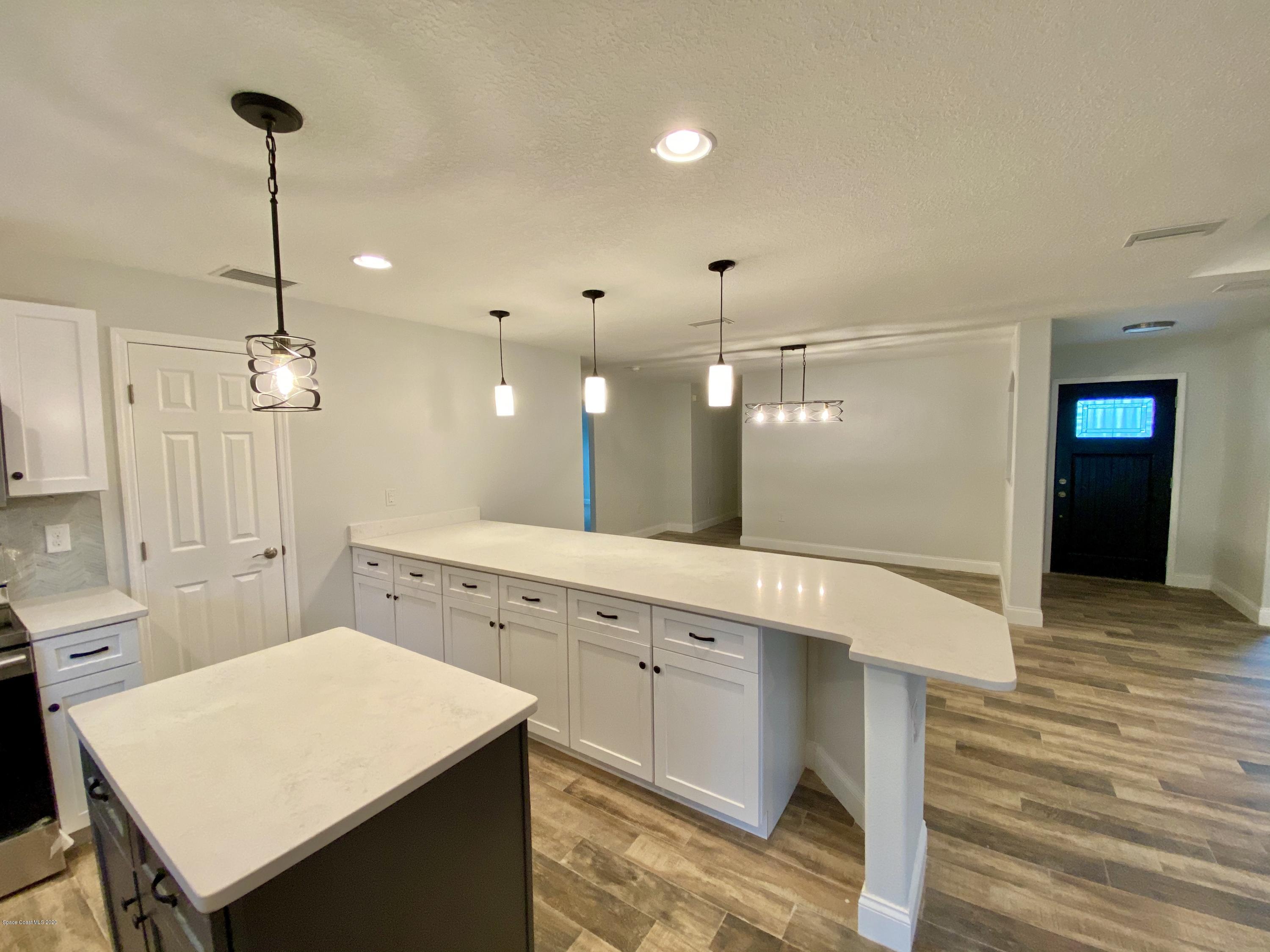 6444 Hudson Road Cocoa, FL 32927 - Photo 6 of 21 a large kitchen with a table and chairs