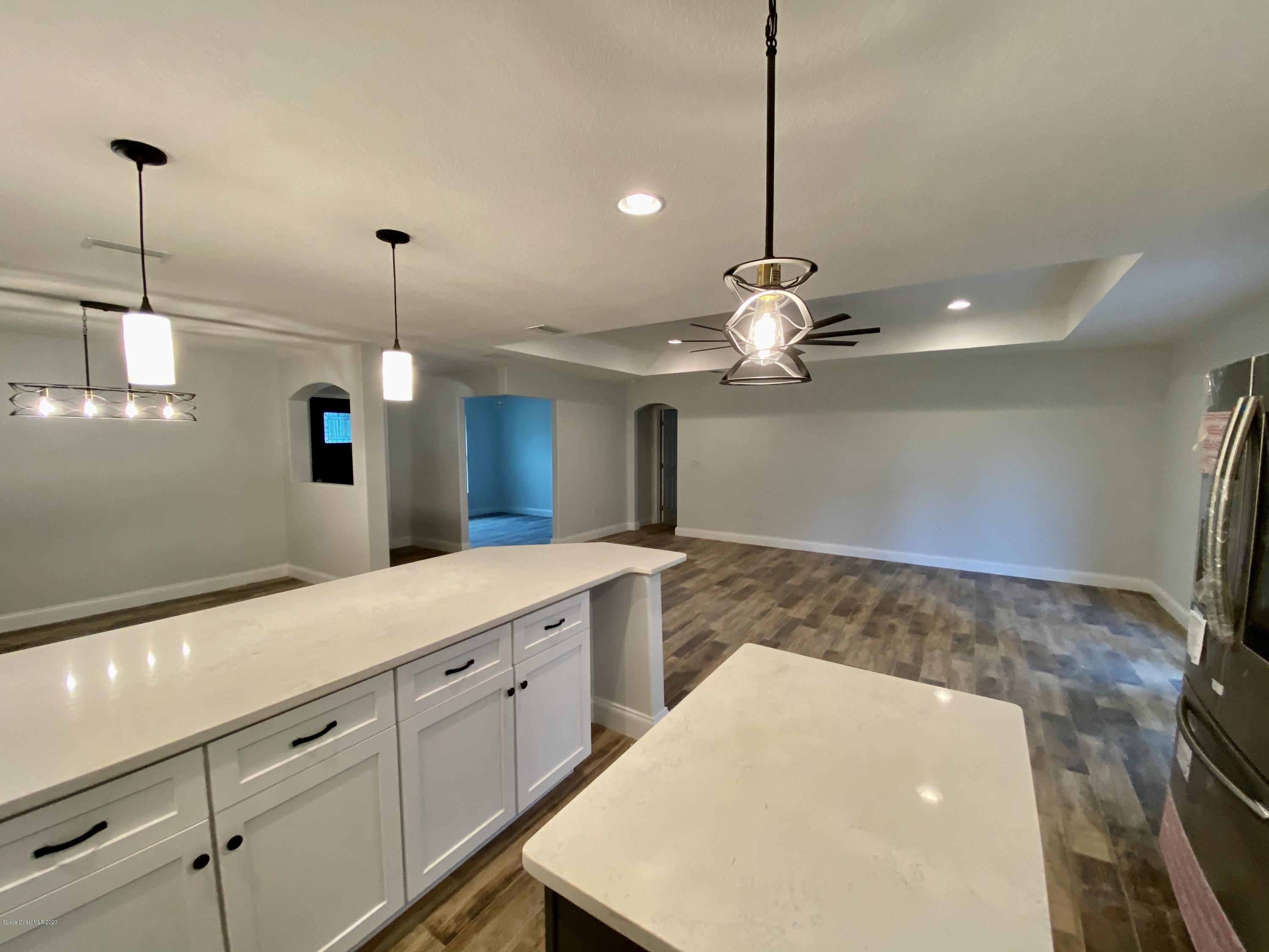 6444 Hudson Road Cocoa, FL 32927 - Photo 7 of 21 a kitchen with stainless steel appliances granite countertop cabinets a sink and a wooden floor