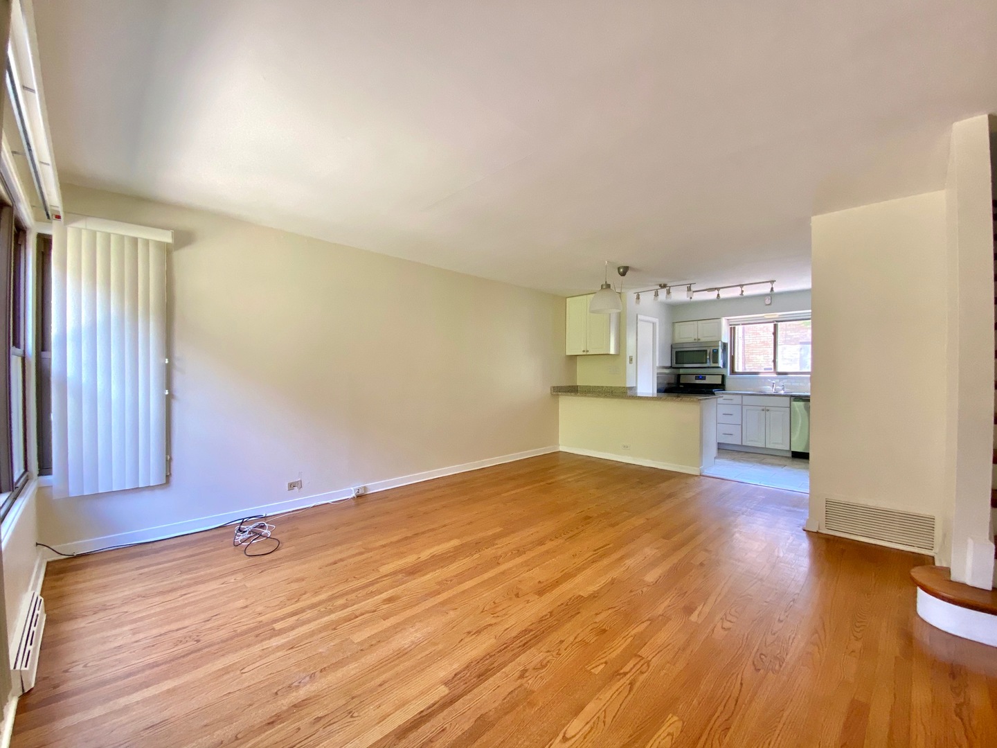 511 Ridge Road, Unit 511 Wilmette, IL 60091 - Photo 3 of 14 a view of empty room with wooden floor and kitchen