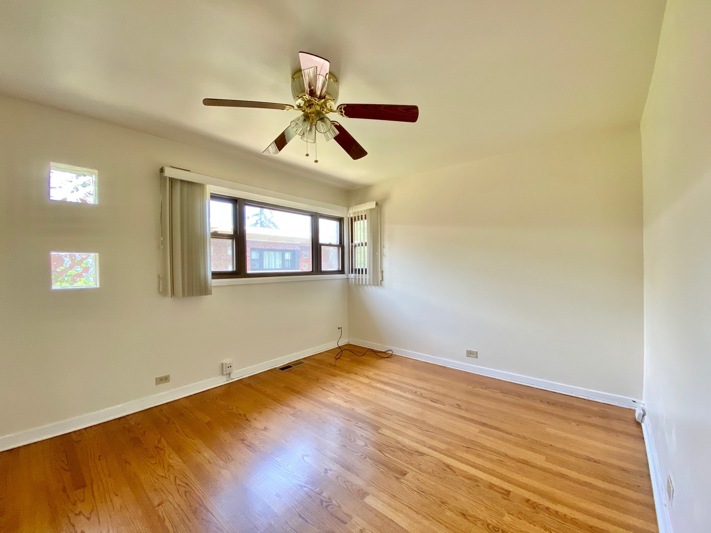 511 Ridge Road, Unit 511 Wilmette, IL 60091 - Photo 10 of 14 a view of empty room with wooden floor and fan