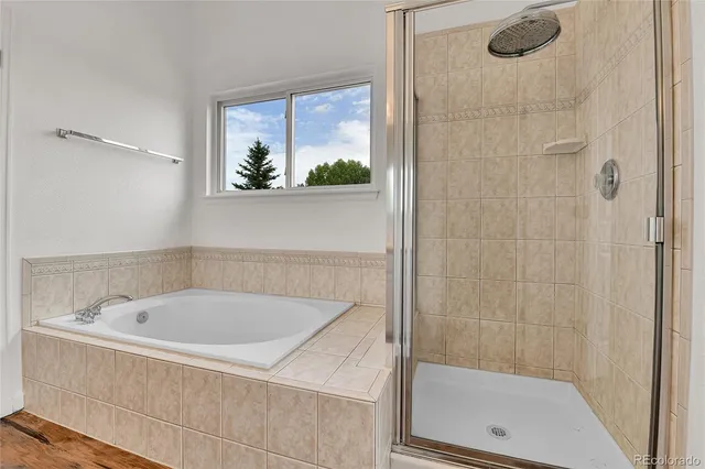 a white bath tub sitting next to a shower