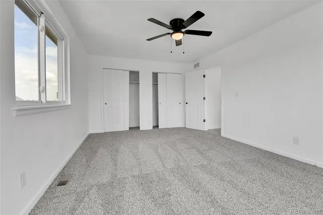 a bathroom with a granite countertop sink toilet a large mirror and shower