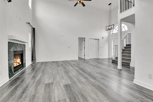 a view of empty room with wooden floor and fireplace