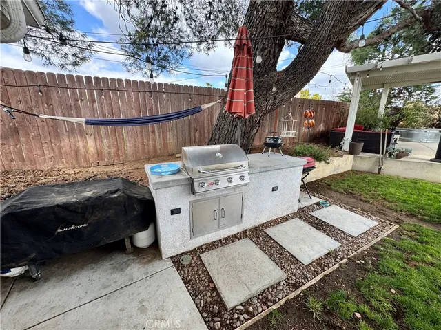 a view of a roof deck with couches and potted plants