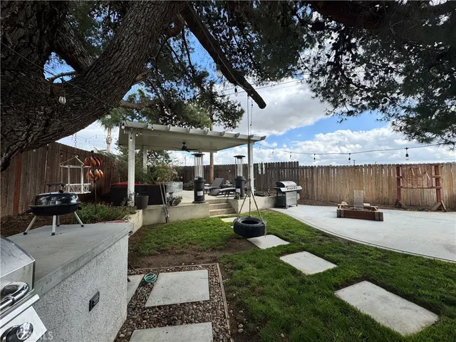 a view of a backyard with sitting area