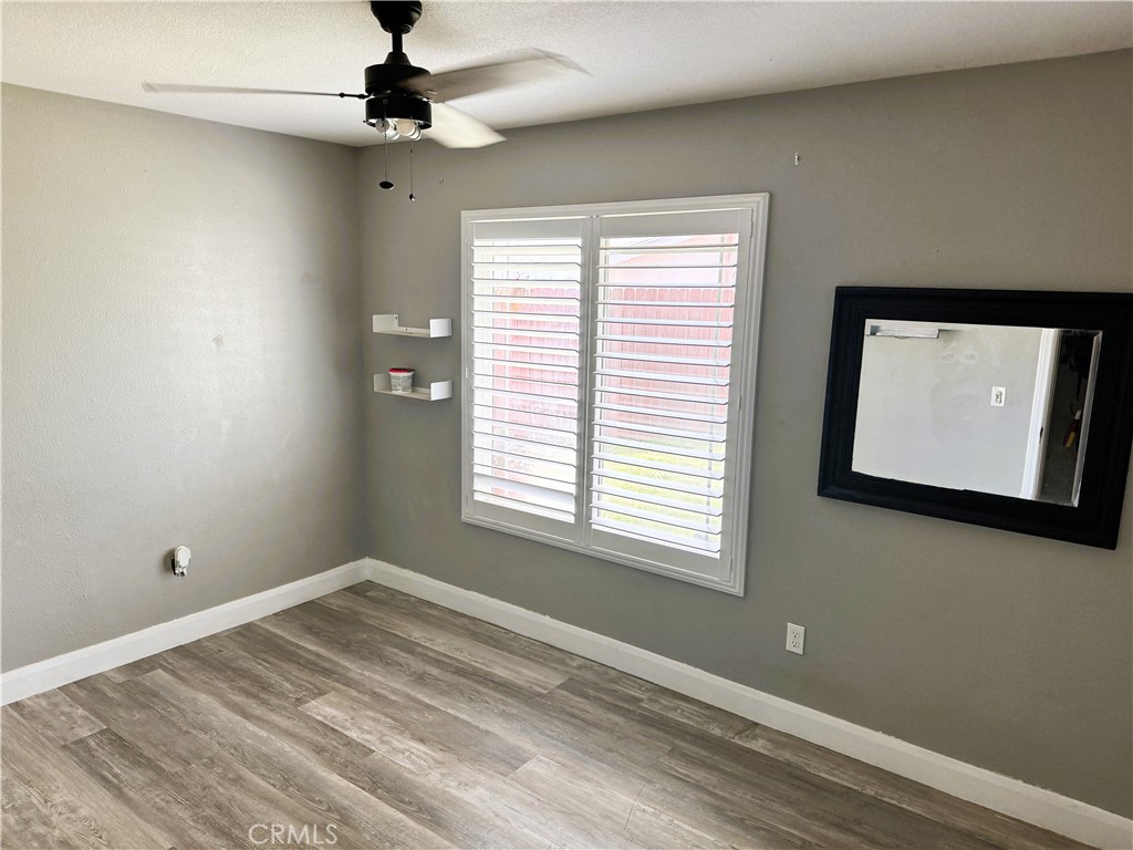 40451 Rome Beauty Way Cherry Valley, CA 92223 - Photo 21 of 25 a view of a livingroom with a ceiling fan and window